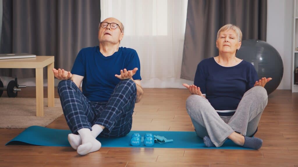 Old couple doing breathing exercise